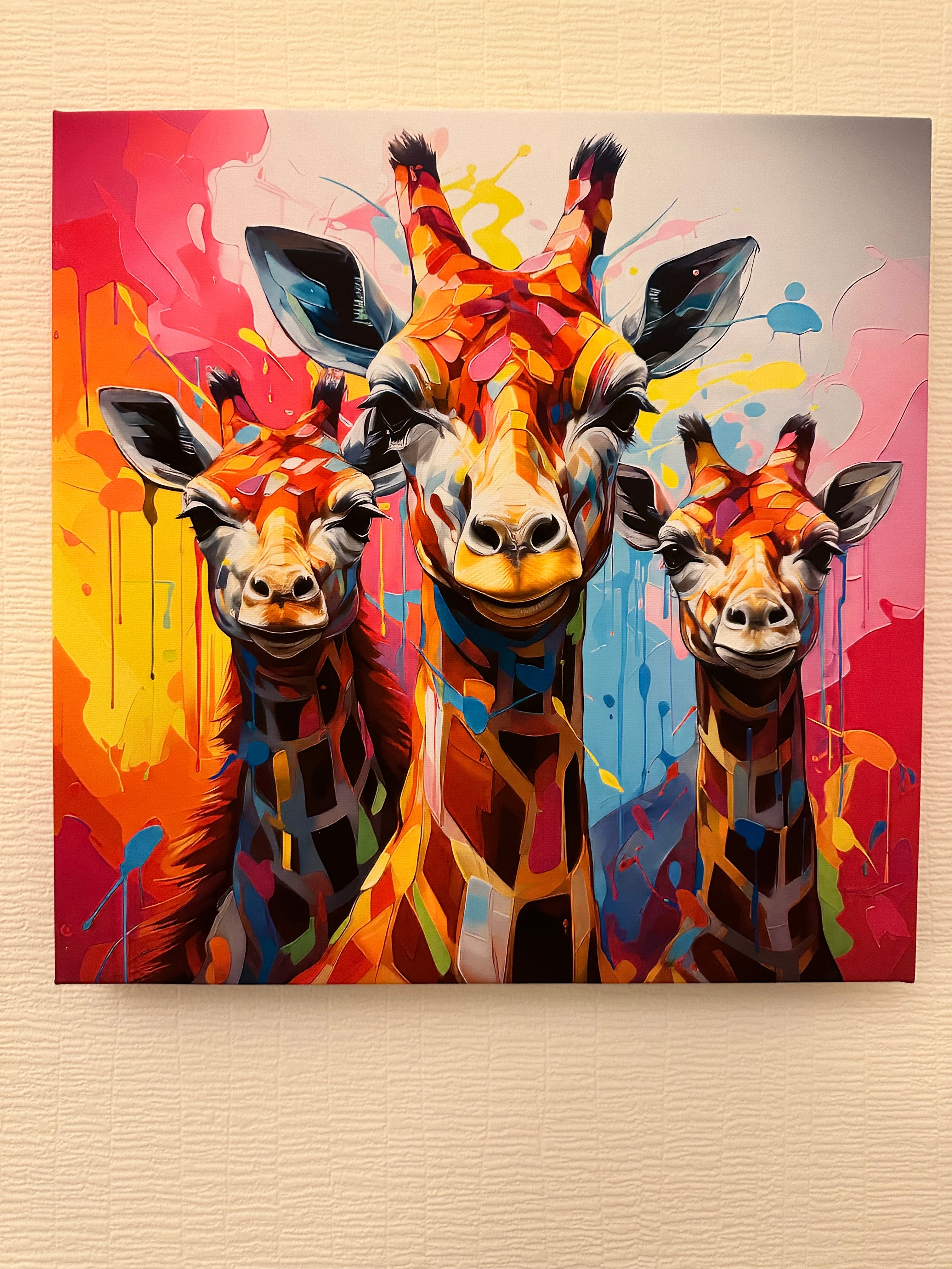Colorful abstract painting of giraffes on a beige wall