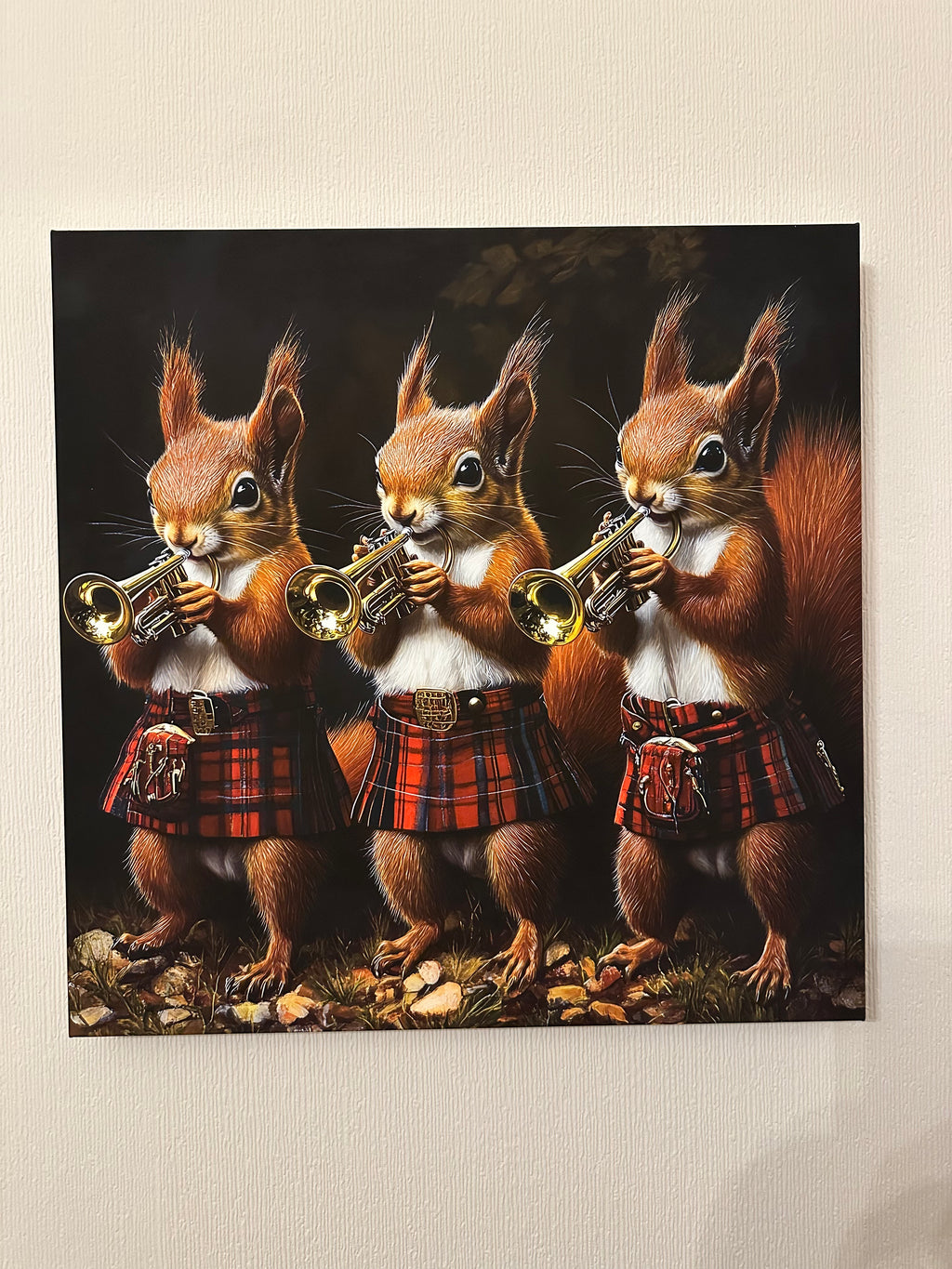 Three squirrels in plaid costumes playing brass instruments on a textured beige background