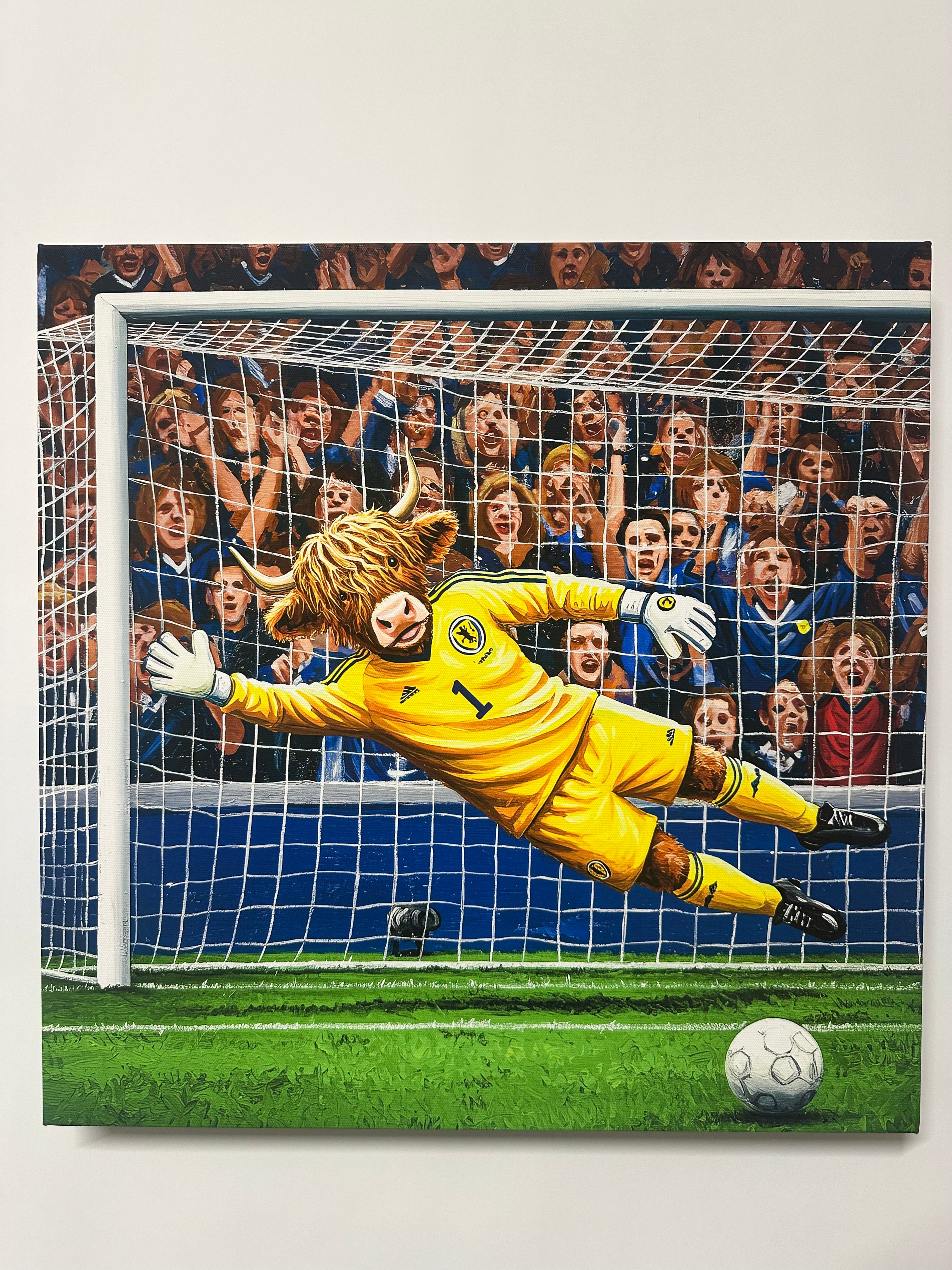 Soccer goalkeeper diving to make a save with fans in the stands.