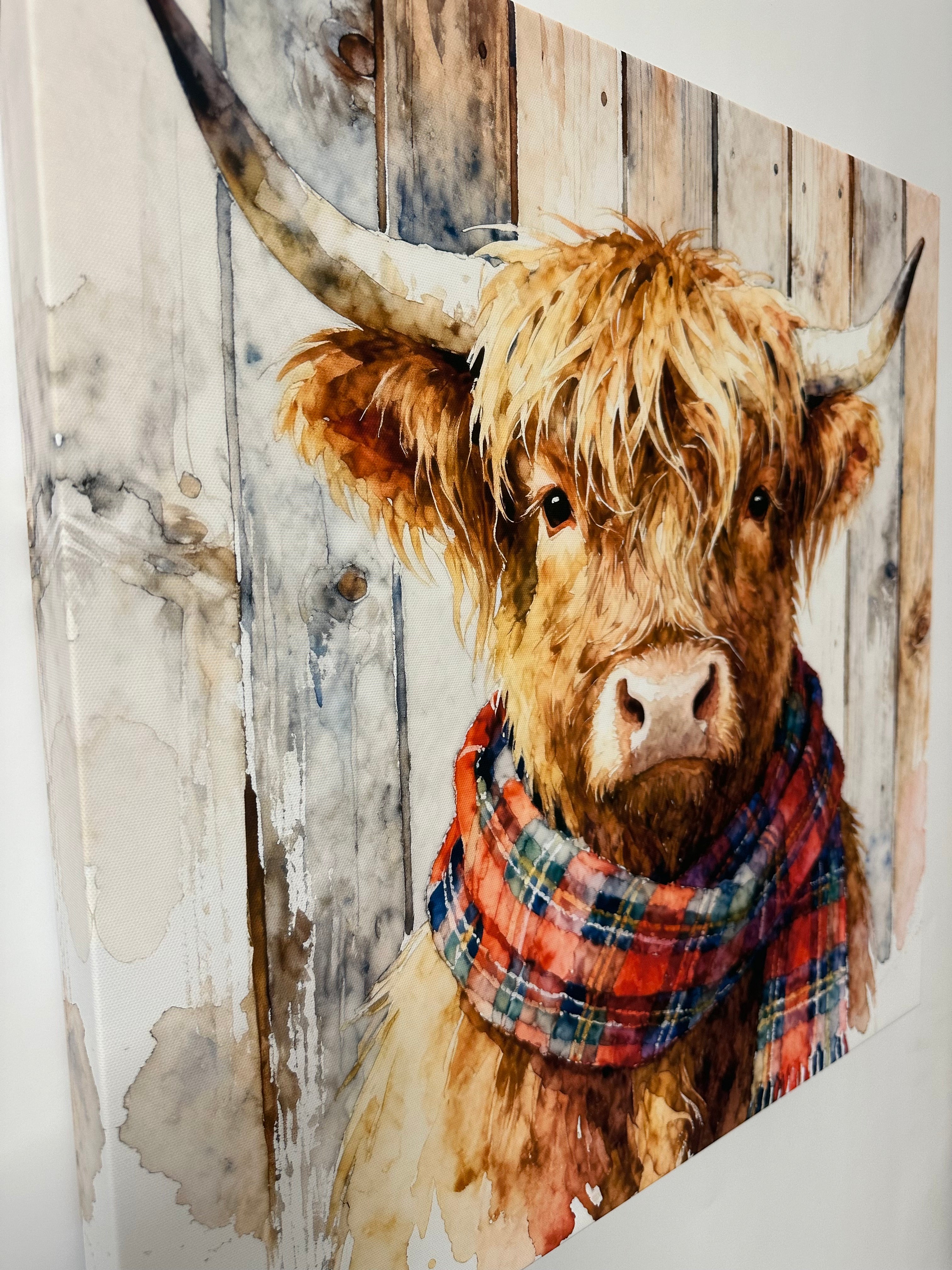 Jimmy the highland cow wearing a plaid scarf on a wooden background the 