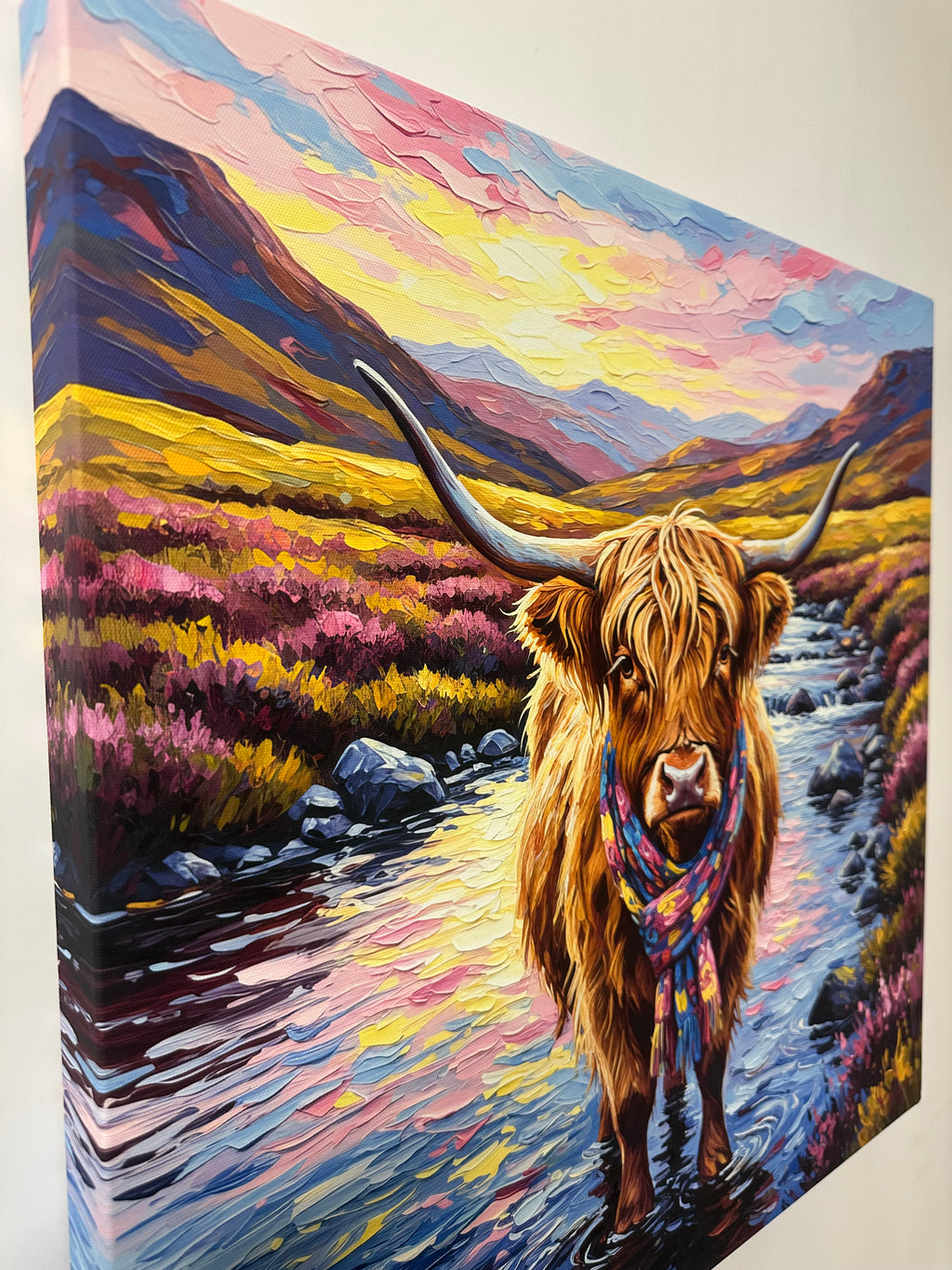 Colorful painting of a highland cow with long horns and a patterned scarf.