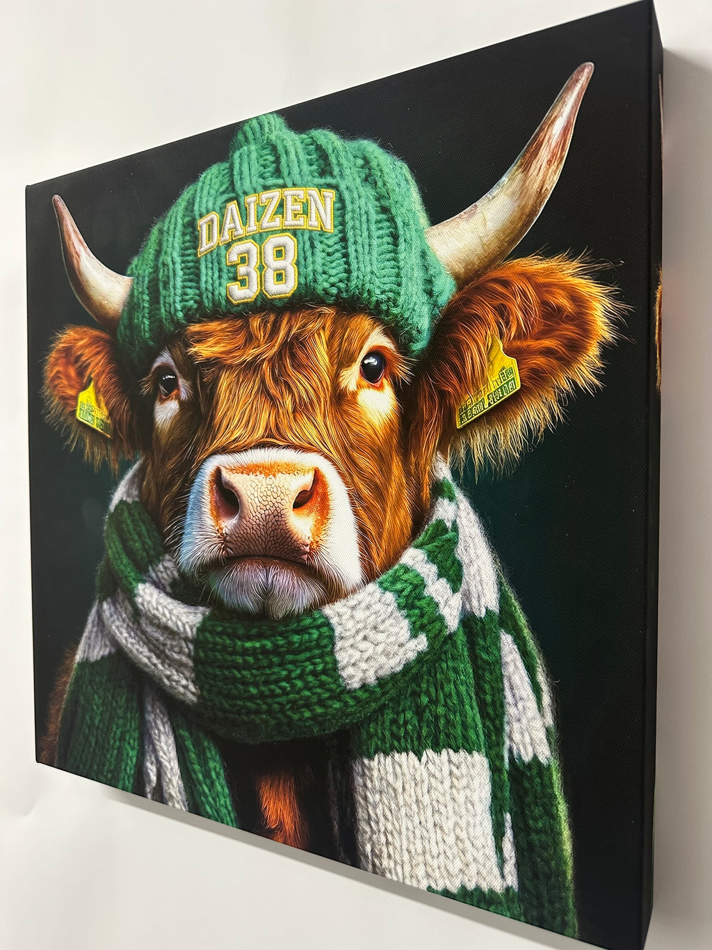 Cow wearing a green knitted hat and scarf on a black background